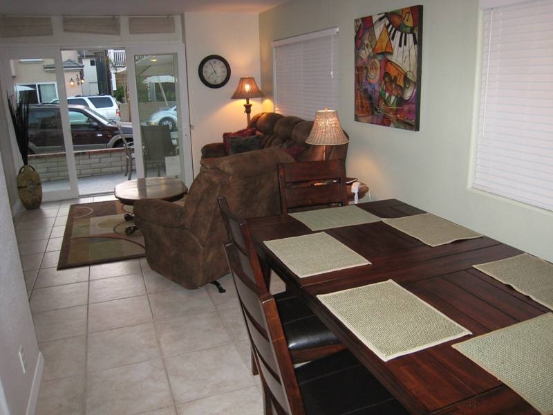 Lower unit dining table and living room with sliding glass door to patio