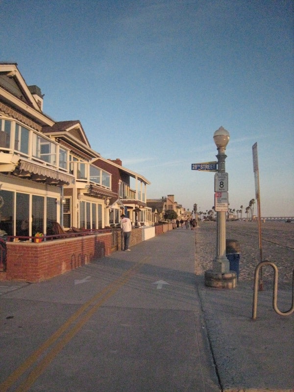 28th Street sign on the Newport Beach boardwalk at golden hour