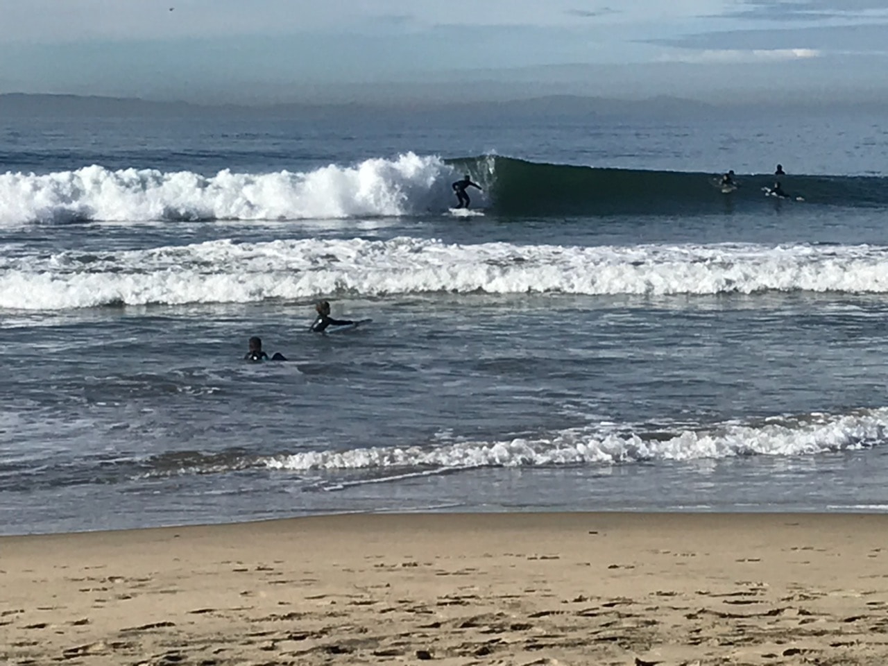 Surfers riding waves at Newport Beach