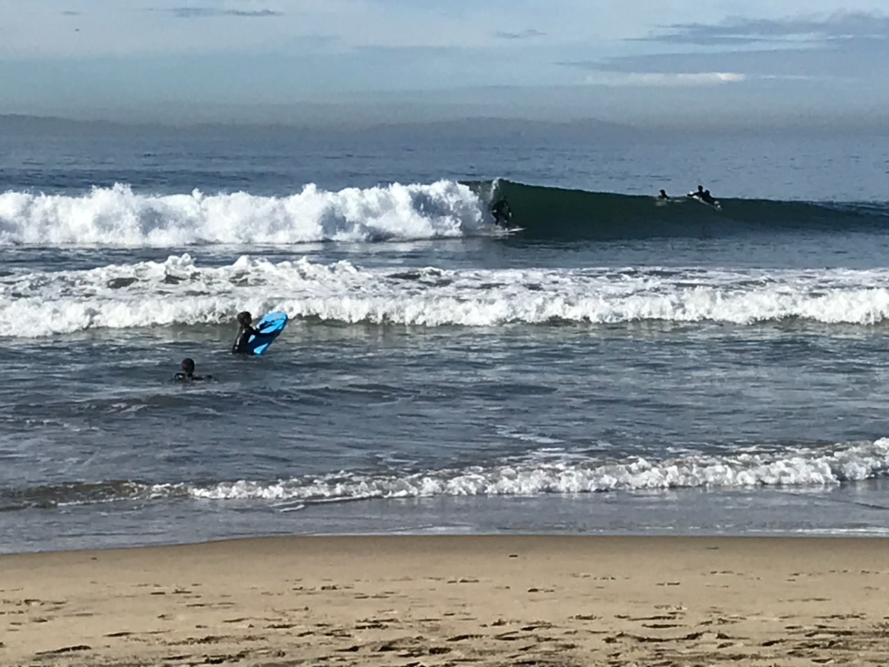 Surfers riding waves at Newport Beach