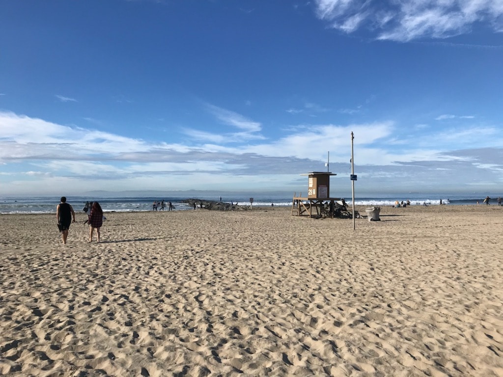 Sandy beach with lifeguard tower and visitors at Newport Beach