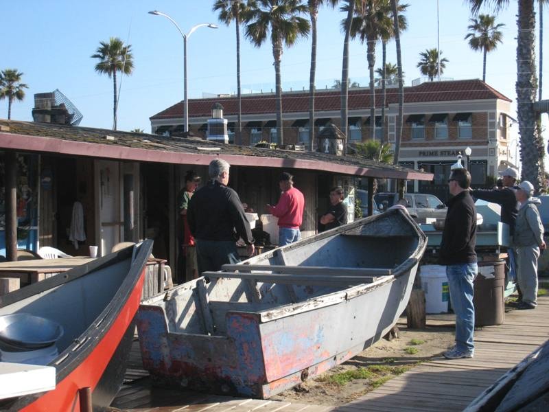 Dory fishing boats at Newport Beach with Prime Steaks restaurant in background