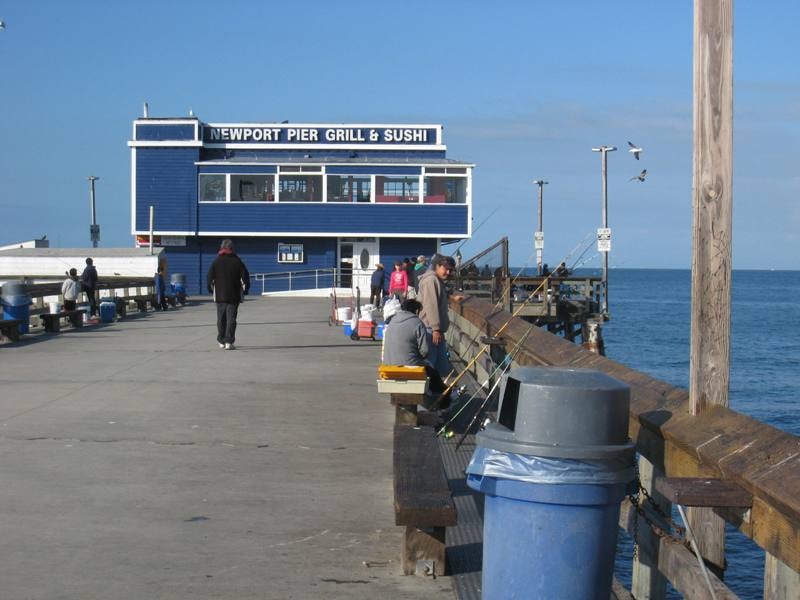 Newport Pier Grill & Sushi restaurant at the end of the pier with anglers