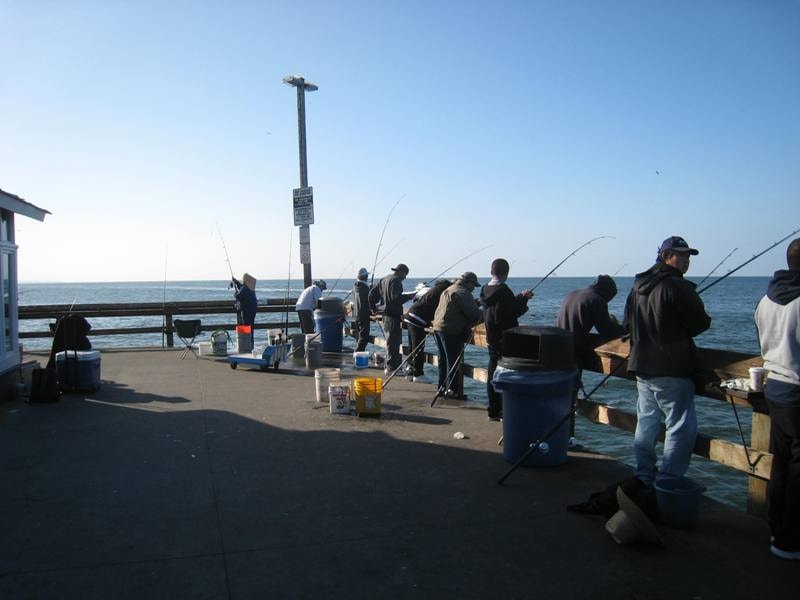 Anglers fishing from Newport Beach Pier at sunrise