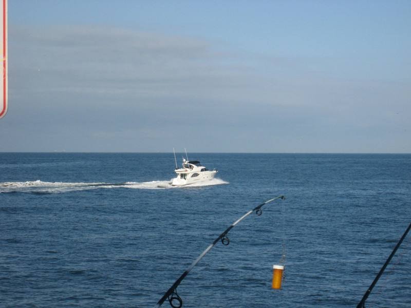 Luxury yacht cruising the Pacific Ocean viewed from Newport Beach Pier