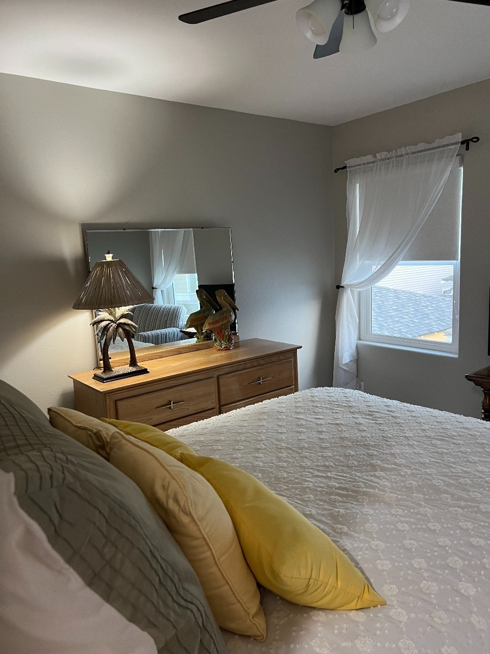 Upper unit master bedroom with queen bed and coastal decor