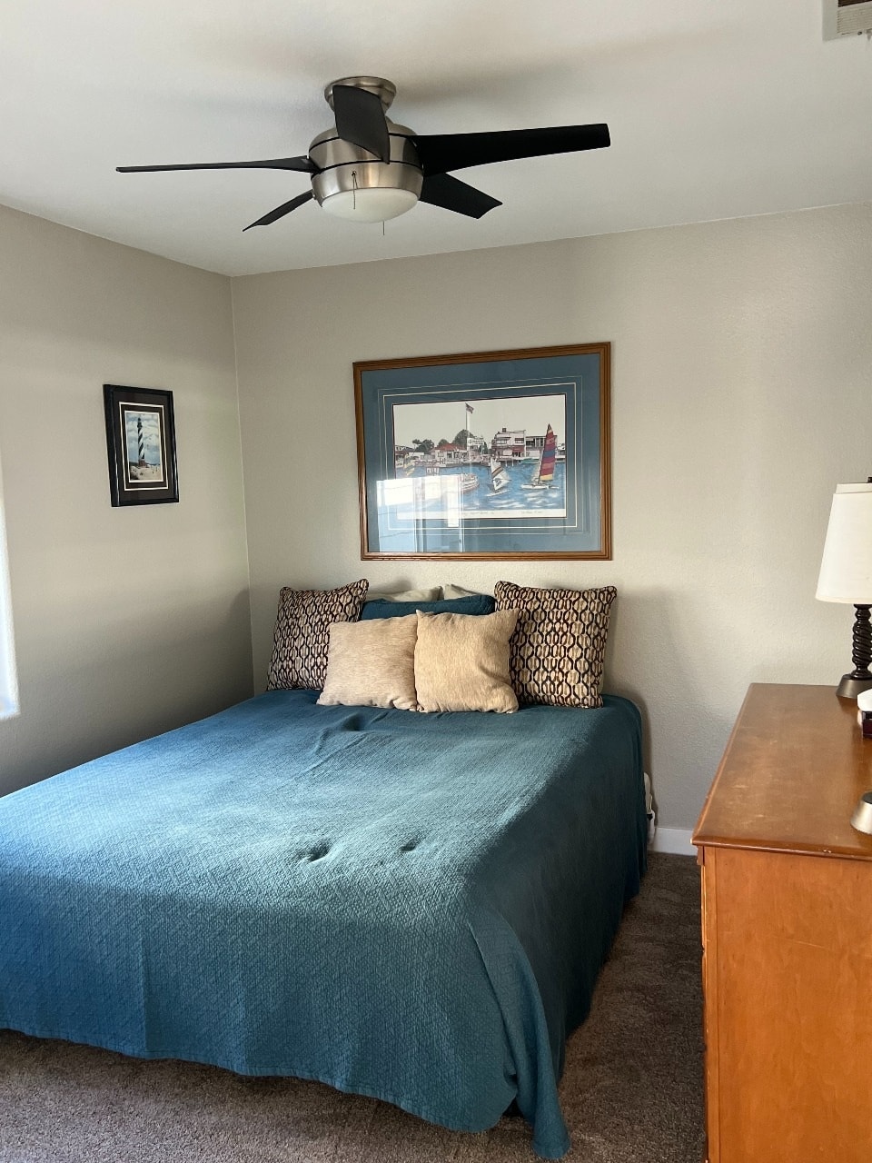 Upper unit second bedroom with queen bed and nautical art