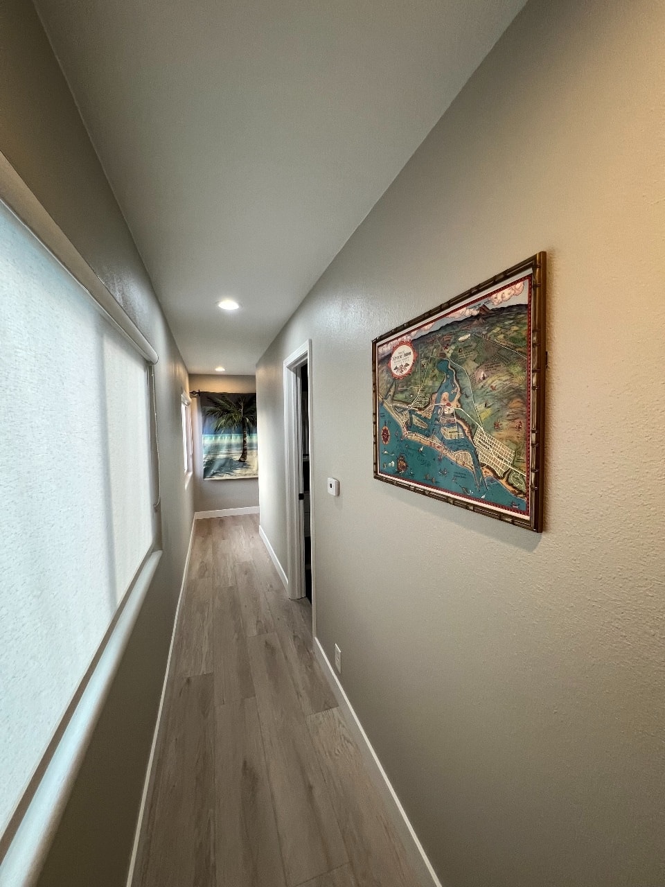 Upper unit second hallway with Newport Beach map and hardwood floors