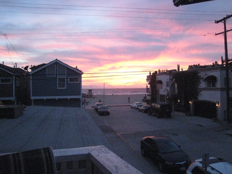 View from upper unit deck looking down the street toward the beach at sunset