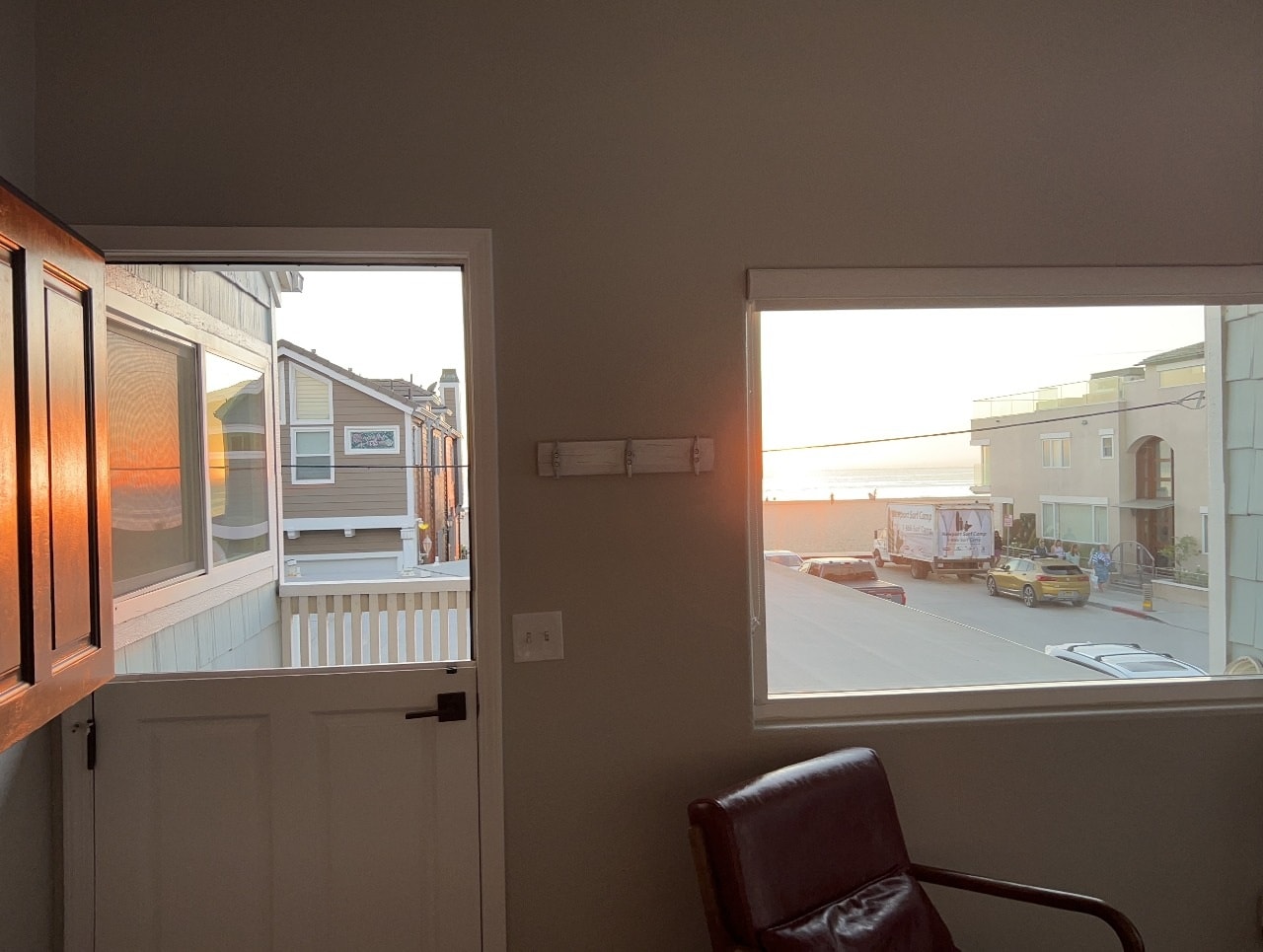 Upper unit windows with golden sunset light and ocean glimpse
